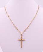 A 9 ct gold cross pendant on a 9 ct gold chain. Cross 3.5 cm high, chain 46 cm long. 7.3 grammes.
