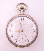 A silver Longines pocket watch. 5 cm diameter.