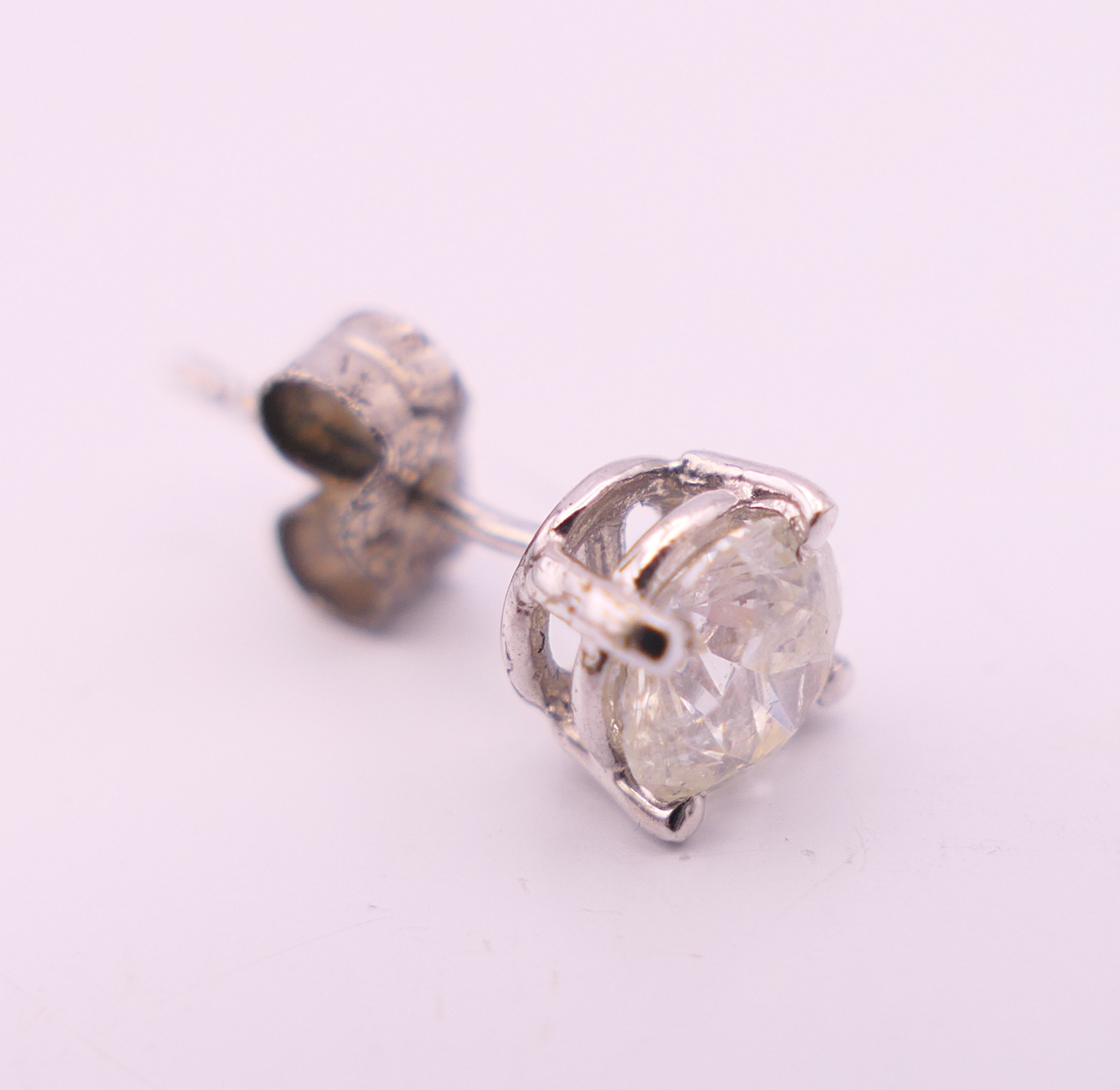 A pair of 18 ct white gold diamond stud earrings. Total diamond weight approximately 1.1 carats. - Image 5 of 5