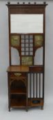 An Arts and Crafts hallstand with inset metal panels. 75 cm wide, 192.5 cm high.