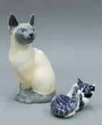 Two Royal Copenhagen porcelain cats. The largest 20 cm high.