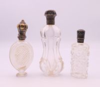 Three French silver topped scent bottles. Tallest 12 cm high.