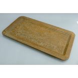 An Eastern carved wooden tray. 66 cm long.
