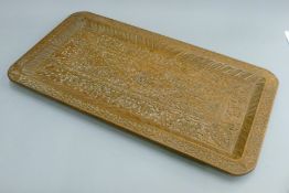 An Eastern carved wooden tray. 66 cm long.