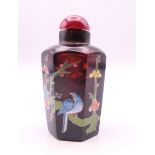 A Chinese snuff bottle painted with a paint amongst foliage. 6.5 cm high.