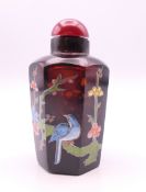 A Chinese snuff bottle painted with a paint amongst foliage. 6.5 cm high.
