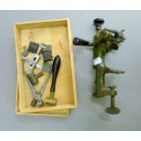 A 19th century gun reloading tool with box of gun bits, including shot measure,