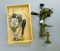 A 19th century gun reloading tool with box of gun bits, including shot measure,