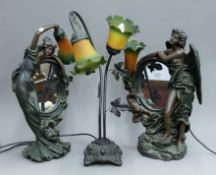A pair of figural mirrored table lamps and another lamp. The latter 58 cm high.