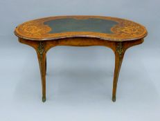 A Victorian inlaid burr walnut kidney shaped writing table. 132 cm wide.