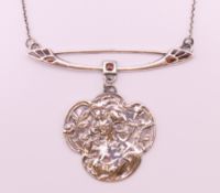 An Art Nouveau style silver pendant. 5 cm high including bar above pendant.