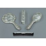 A silver four piece cherub dressing table set.