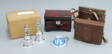 A gas mask, binoculars, two silver plated bells, etc.