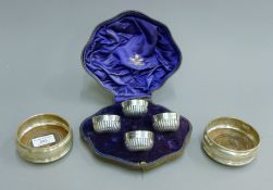 A pair of silver coasters and a boxed Mappin & Webb four piece silver cruet set.