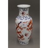 A Chinese porcelain vase decorated with five clawed dragons chasing flaming pearls,