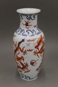 A Chinese porcelain vase decorated with five clawed dragons chasing flaming pearls,