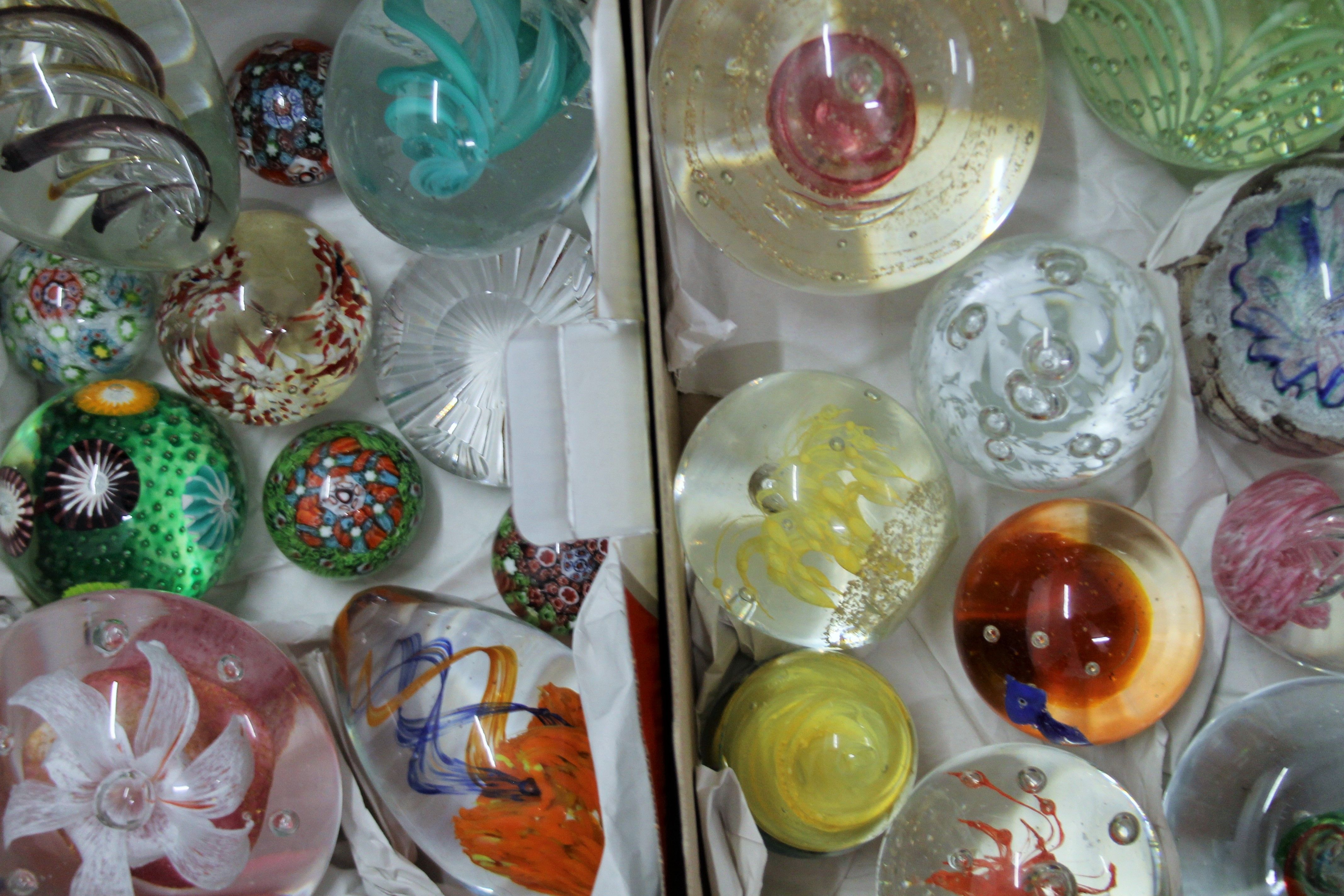 Three boxes of paperweights.