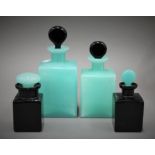 Four green and black glass scent bottles. The largest 19 cm high.