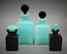 Four green and black glass scent bottles. The largest 19 cm high.