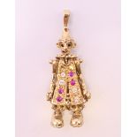A 9 ct gold gemstone (cubic zirconia) set articulated circus clown pendant.