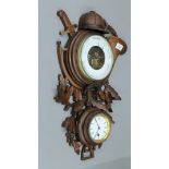 A 19th century Blackforest clock/barometer carved with sporting trophies. 54 cm high.