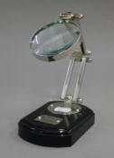 A small chrome magnifying glass on stand.