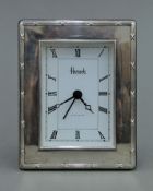 A silver Harrods clock. 9 cm wide.