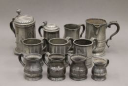 A collection of various antique pewter tankards.