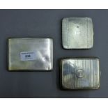 Three silver cigarette cases. The largest 11.5 cm wide.