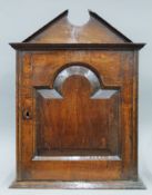 An 18th century oak spice cupboard.