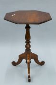 A Victorian walnut octagonal tilt top tripod table. 55 cm wide.
