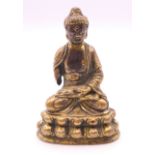 An 18th century miniature gilt bronze model of Buddha. 6.5 cm high.