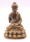 An 18th century miniature gilt bronze model of Buddha. 6.5 cm high.