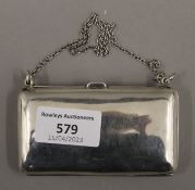 A silver purse. 9.5 cm wide.