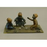 A cold painted bronze model of boys playing dice. 20 cm wide.