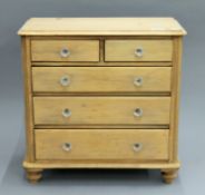 A Victorian miniature pine chest of drawers. 47 cm wide x 48 cm high.