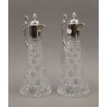 A pair of silver mounted cut glass claret jugs. 30.5 cm high.