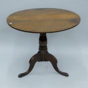 A George III oak tripod table. 87 cm diameter.