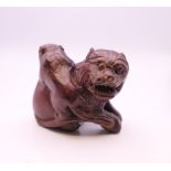 A wooden dog-of-fo and monkey carving. 3.5 cm high.