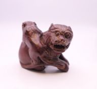 A wooden dog-of-fo and monkey carving. 3.5 cm high.