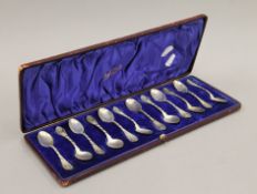 A cased set of twelve silver teaspoons, in a Maple & Co box. 165.5 grammes.