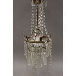 A brass and cut glass chandelier. Approximately 60 cm high.