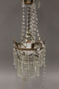 A brass and cut glass chandelier. Approximately 60 cm high.
