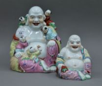 Two Chinese porcelain models of Buddha. The largest 24 cm high.