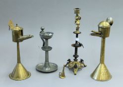Four various antique lamps. The largest 33.5 cm high.