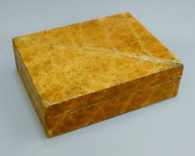 A tobacco leaf covered cigar box. 25.5 cm wide.