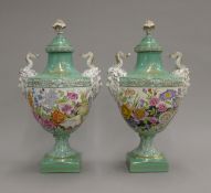 A pair of porcelain lidded vases with floral decoration. 40 cm high.