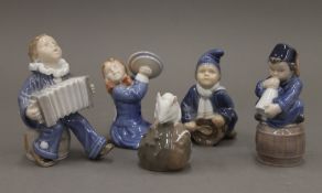 Four Royal Copenhagen models of musician children and a mouse. The largest 11 cm high.