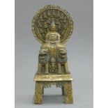A gilt bronze model of Buddha seated on two dogs-of-fo. 27 cm high.