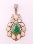 A silver opal, emerald and diamond set pendant. 5 cm high including suspension loop.